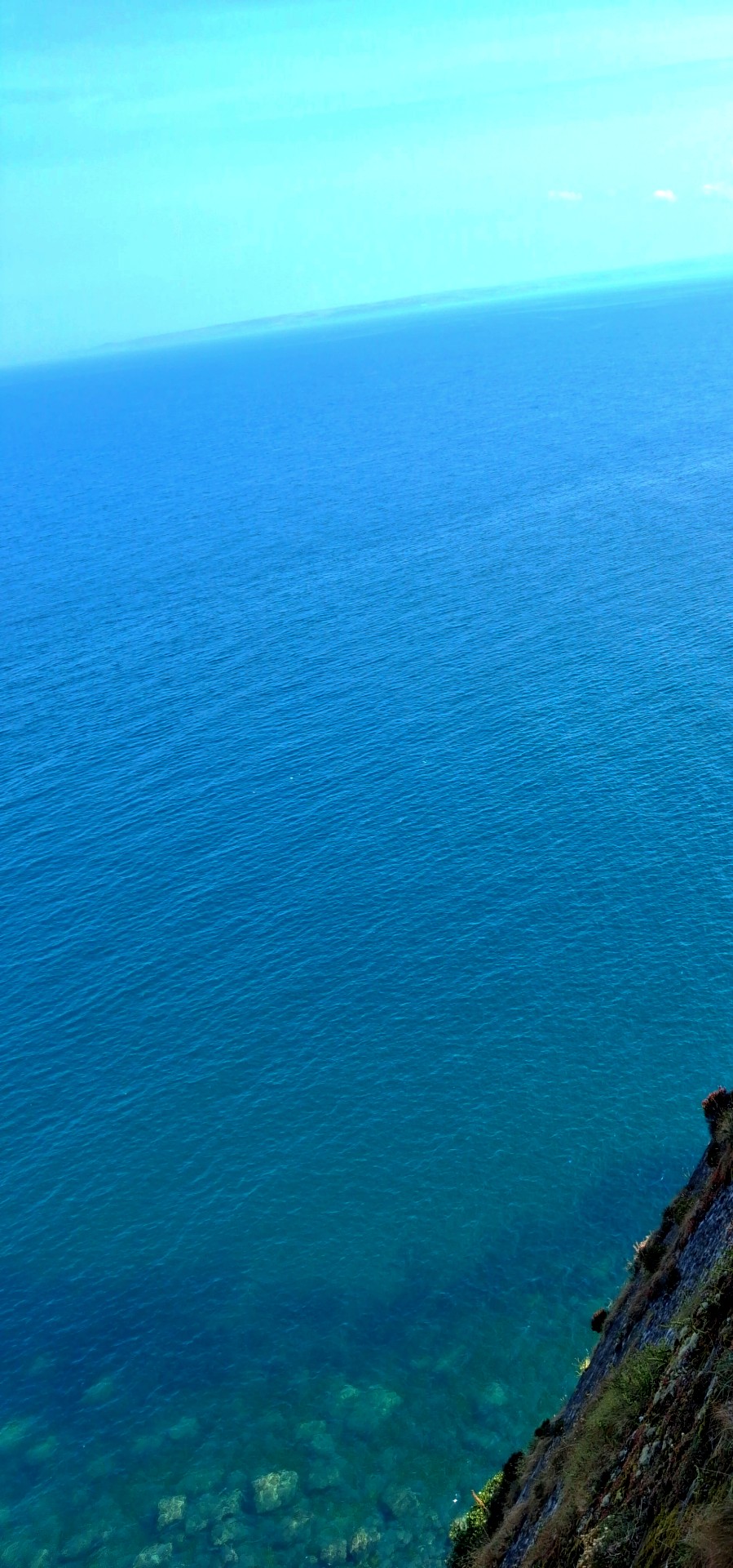 cliff drop into blue sea on the North Devon coast